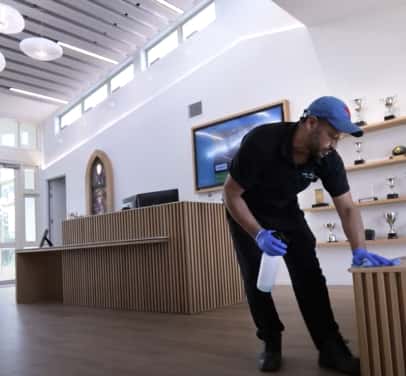 Man cleaning the surface in the office