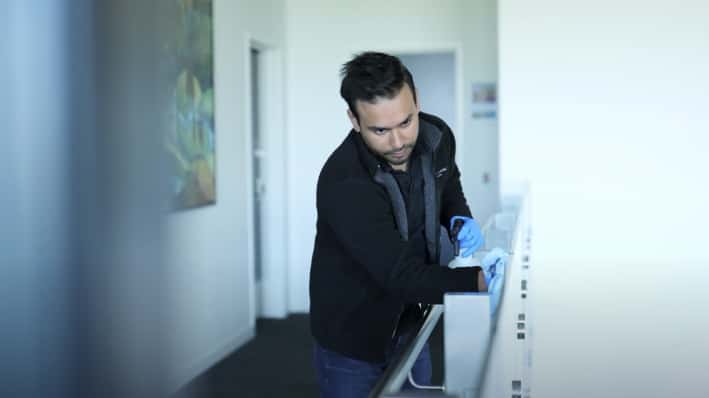 Asset Cleaning's Team Member cleaning the glass