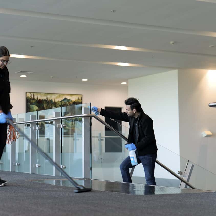Asset Cleaning Team Member cleaning glass and carpet