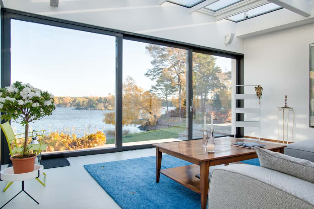 beautiful view of a blue lake captured from the inside of a villa