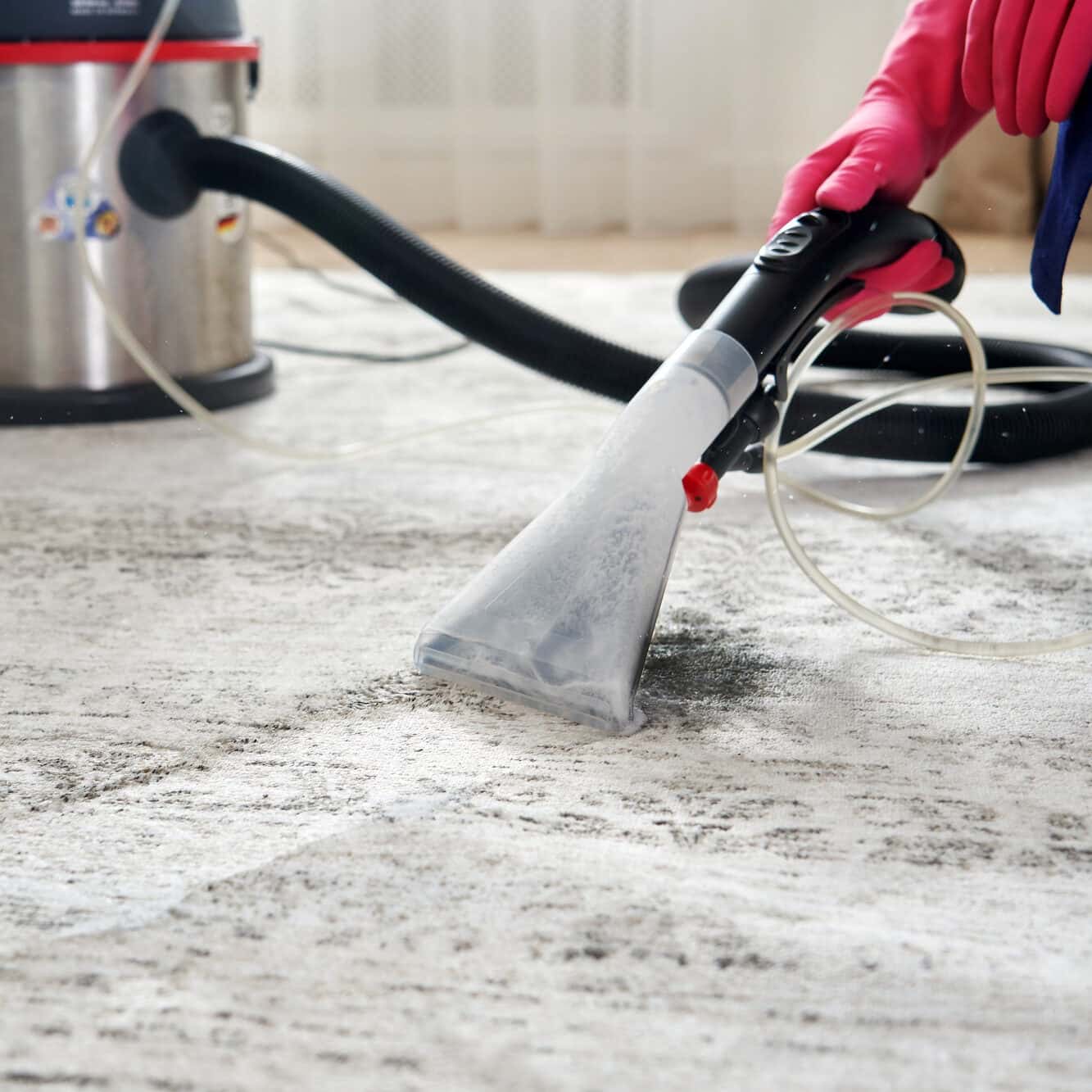 cleaning carpet in the living room using vacuum cleaner at home
