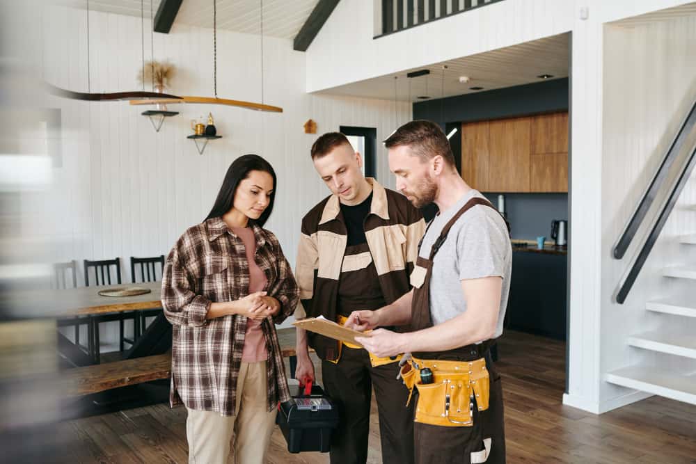 young-plumber-uniform-giving-document-female-her-signature